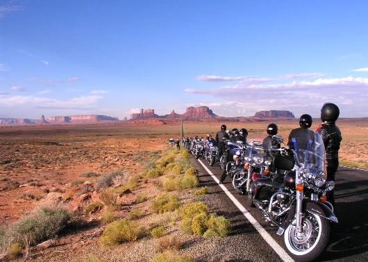 Monument Valley with Orange & Black motorcycle tour bikes in foreground