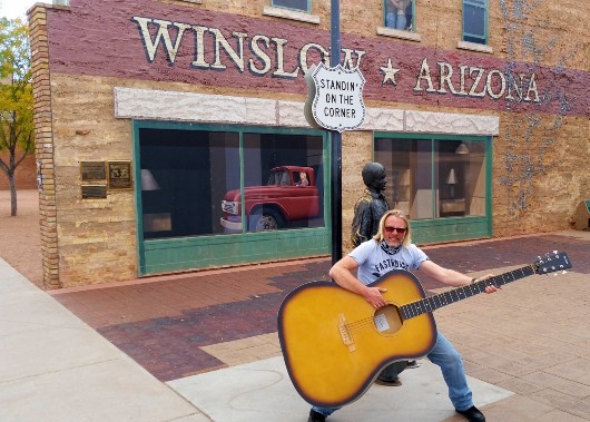 Henry Cole on Route 66 with orange & Black at Winslow Arizona